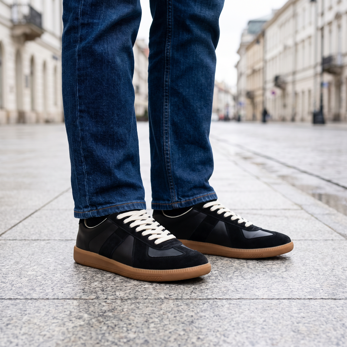Czarne sneakersy retro na stopach do jeansów