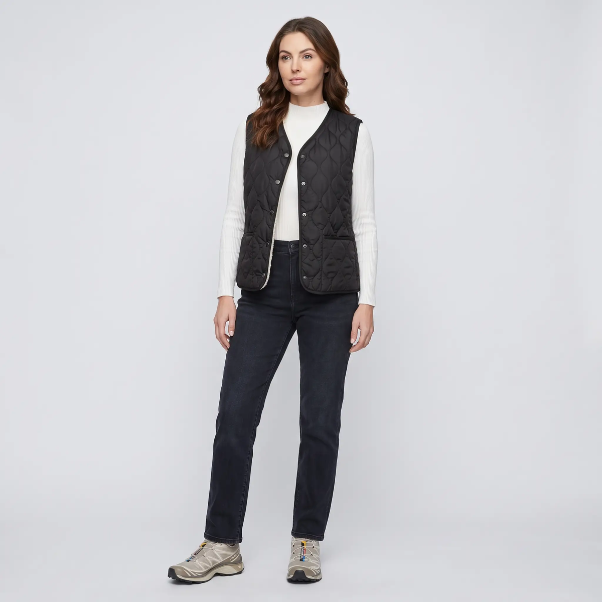 Full-length look - women's Black puffer vest with jeans and sneakers